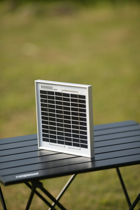 a white and black electronic device on a black table