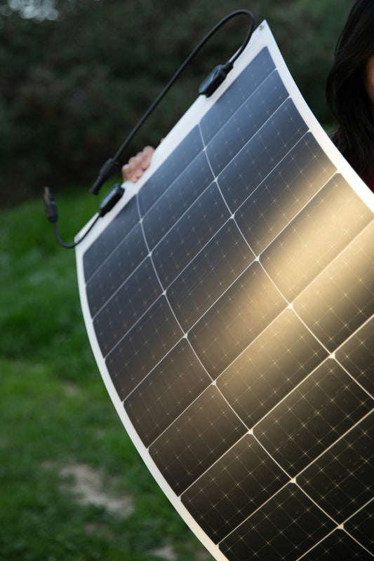 a woman holding a solar panel in her hands