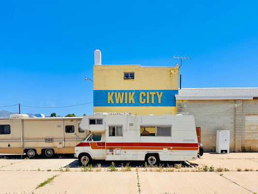 a couple of rvs parked in front of a building