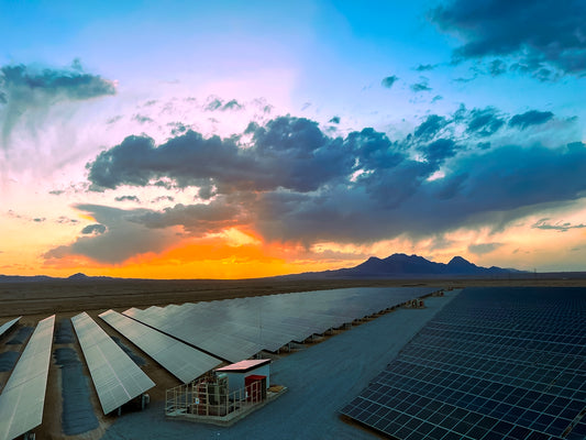a large array of solar panels in a desert