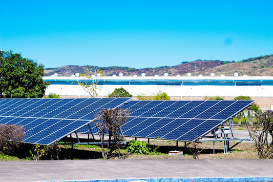 a row of solar panels sitting next to a swimming pool