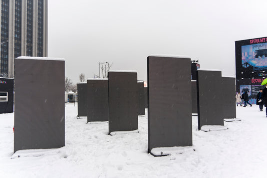 a group of metal posts sitting on top of a snow covered ground