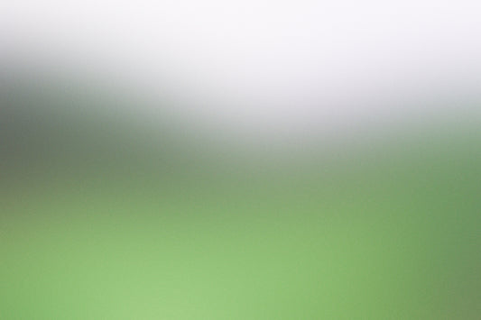 a blurry image of a green and white background