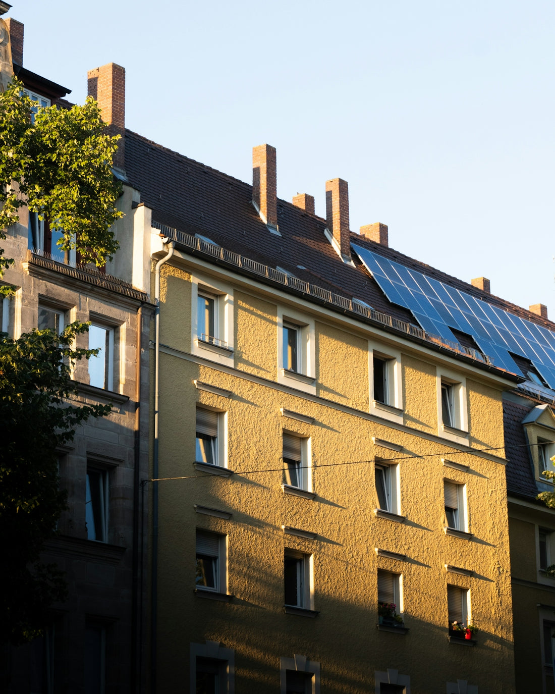 A row of buildings with a solar panel on the roof