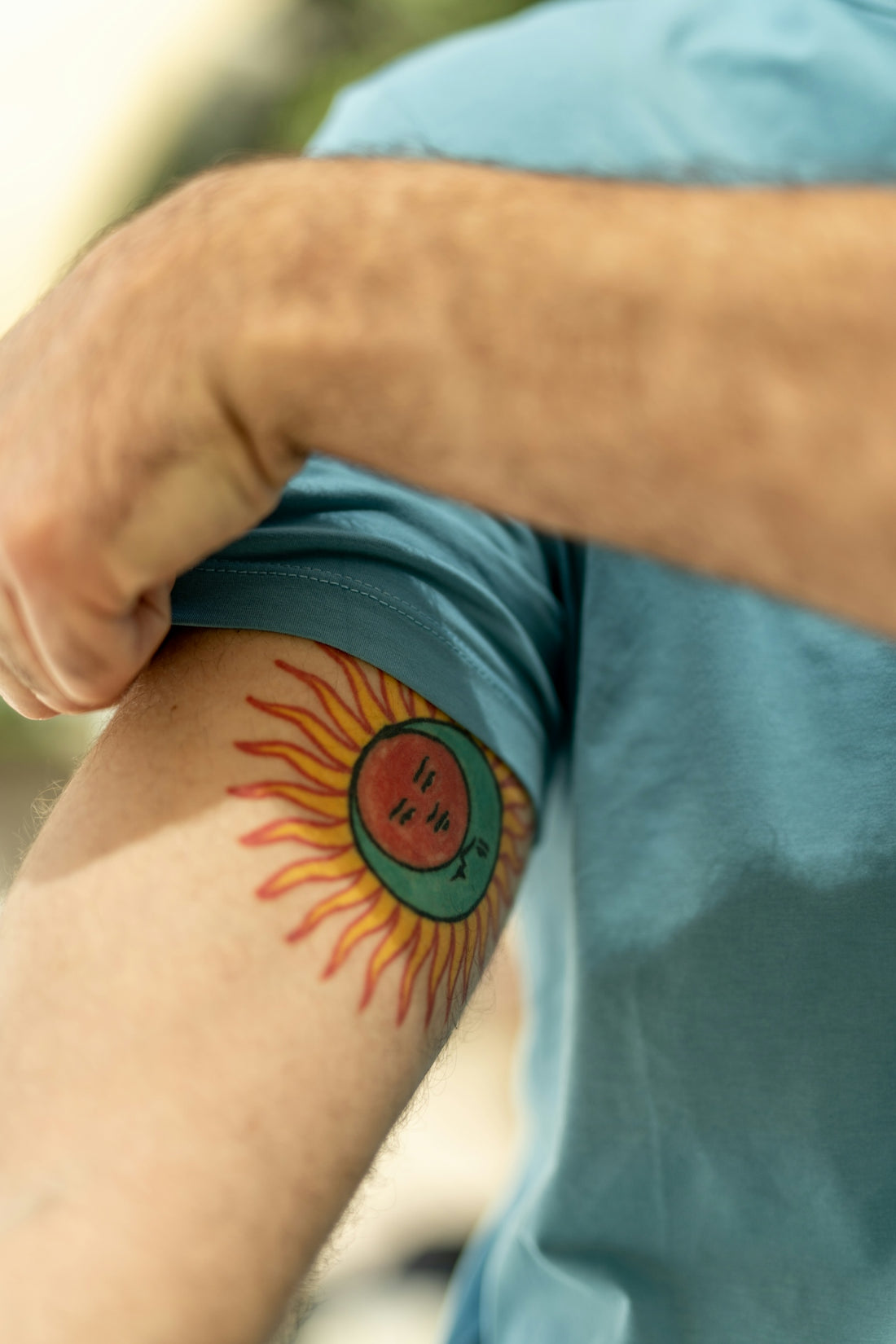 a close up of a person with a tattoo on his arm