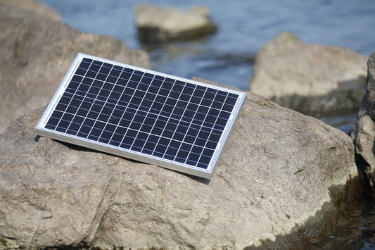a solar panel on a rock
