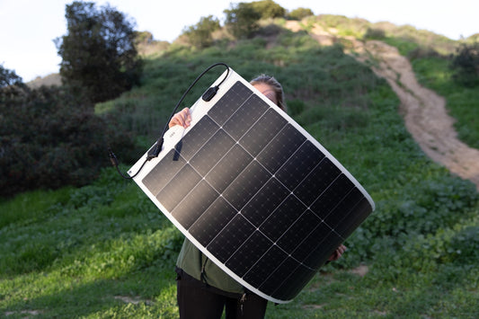 a man carrying a solar panel on his back