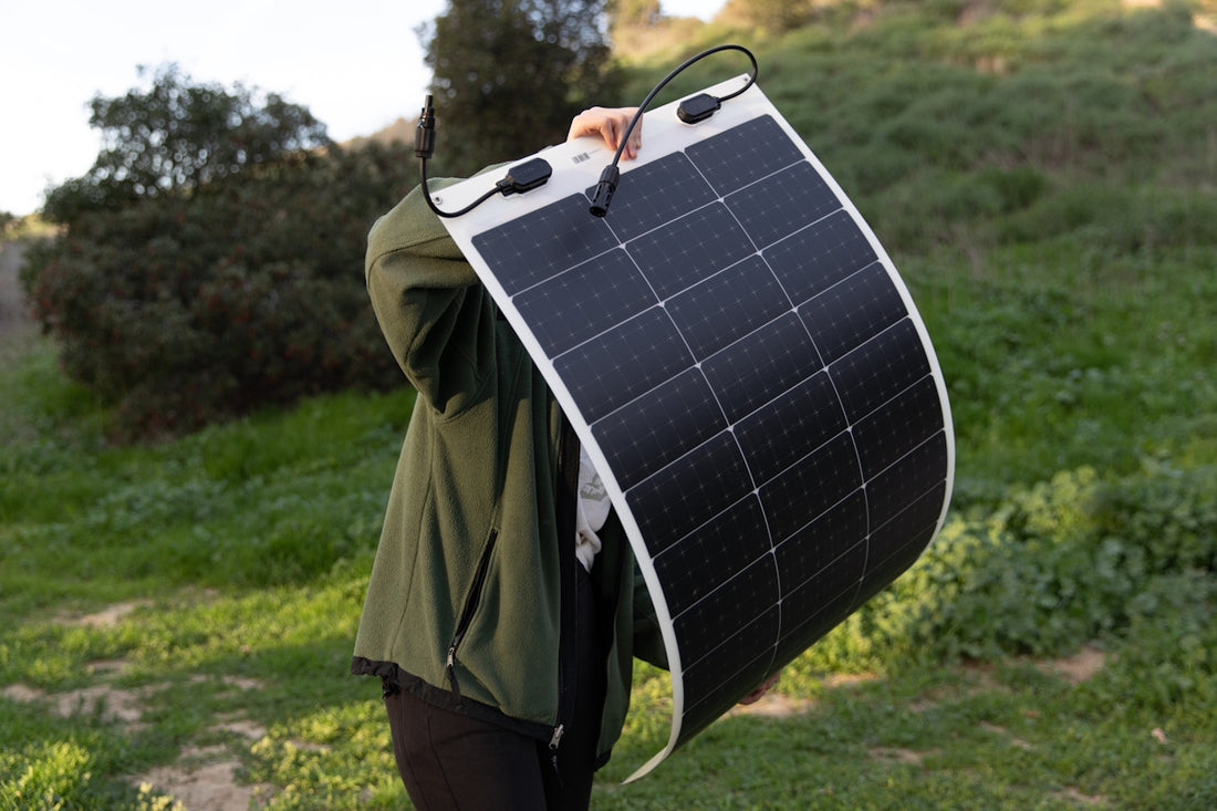a man holding a solar panel on his back