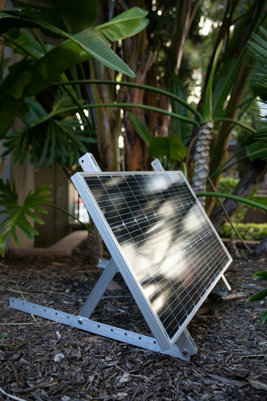 a solar panel sitting on top of a metal stand