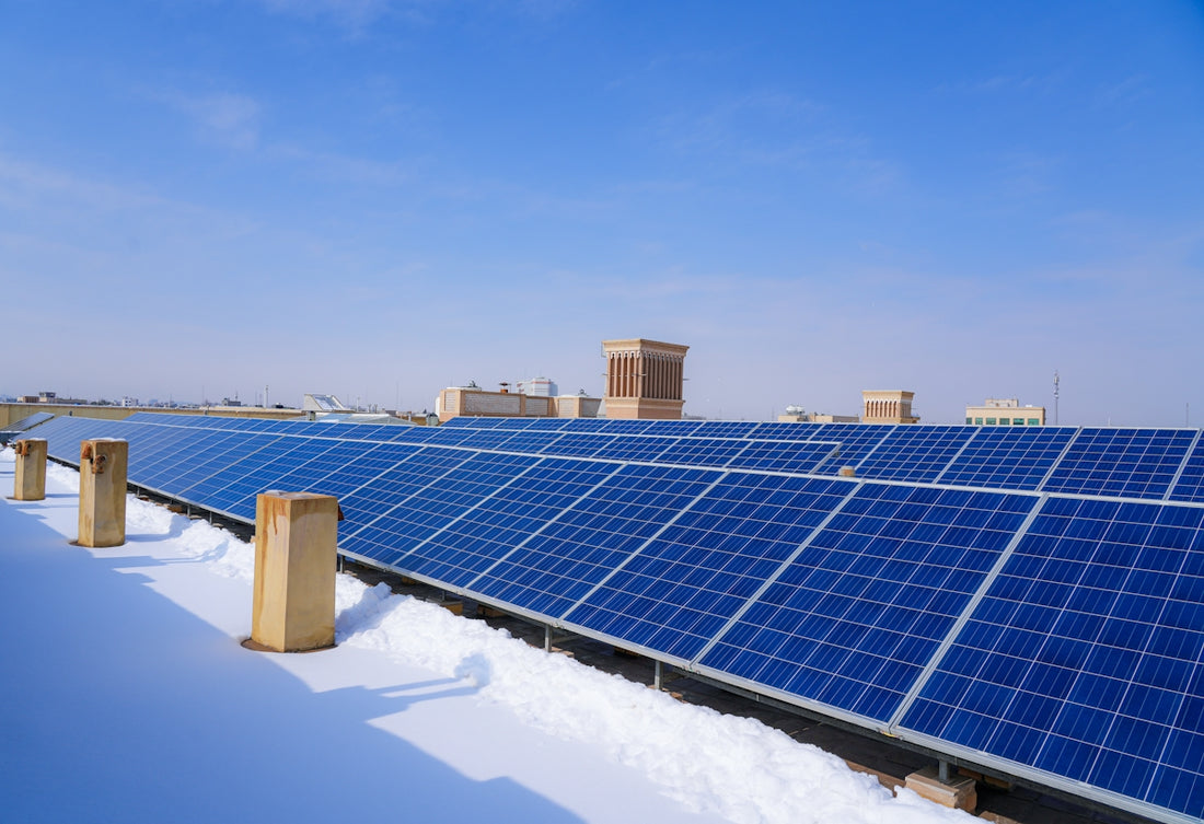 a row of solar panels sitting on top of snow covered ground