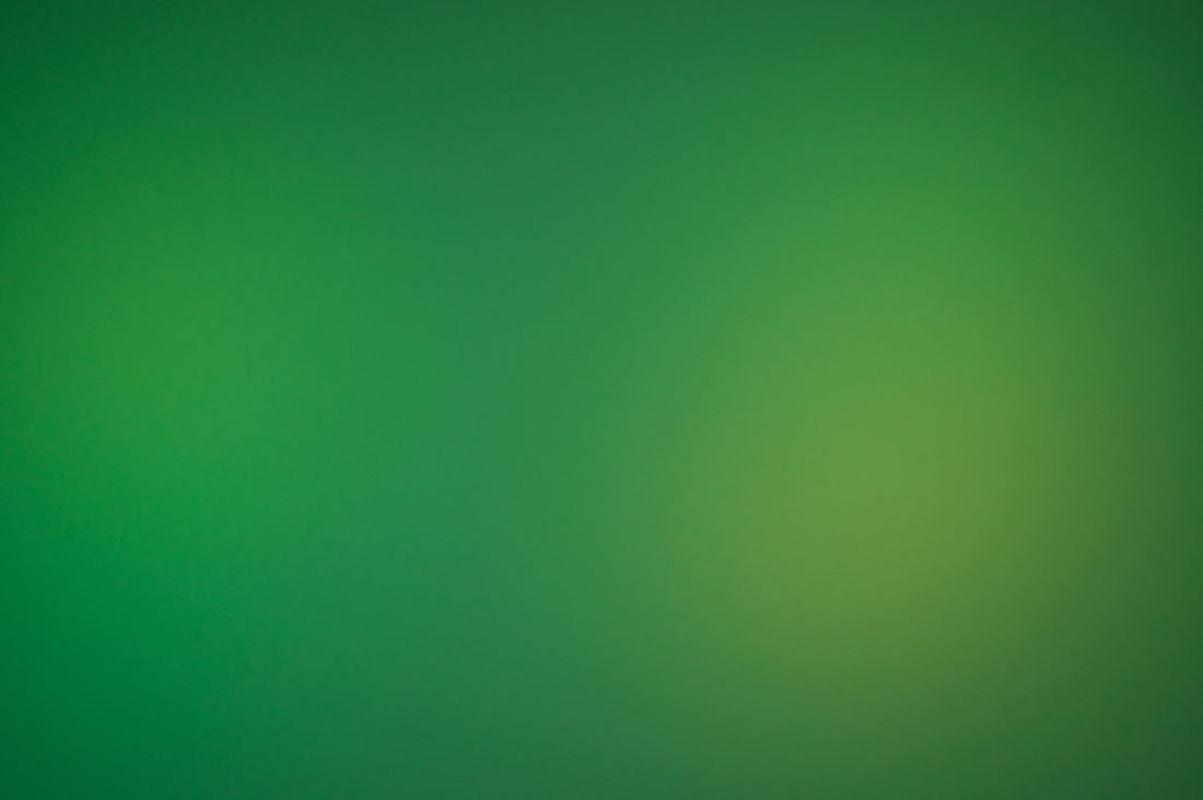a blurry green background with a white border