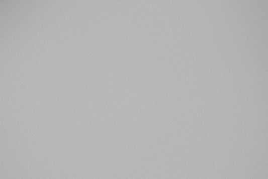 a black and white photo of a plane flying in the sky