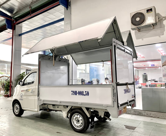 A small food cart parked inside of a building
