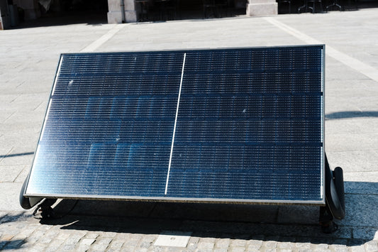 Solar panel angled on a stone surface.