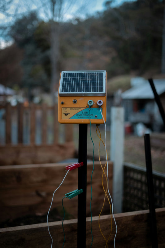 A solar-powered electric fence energizer is displayed.