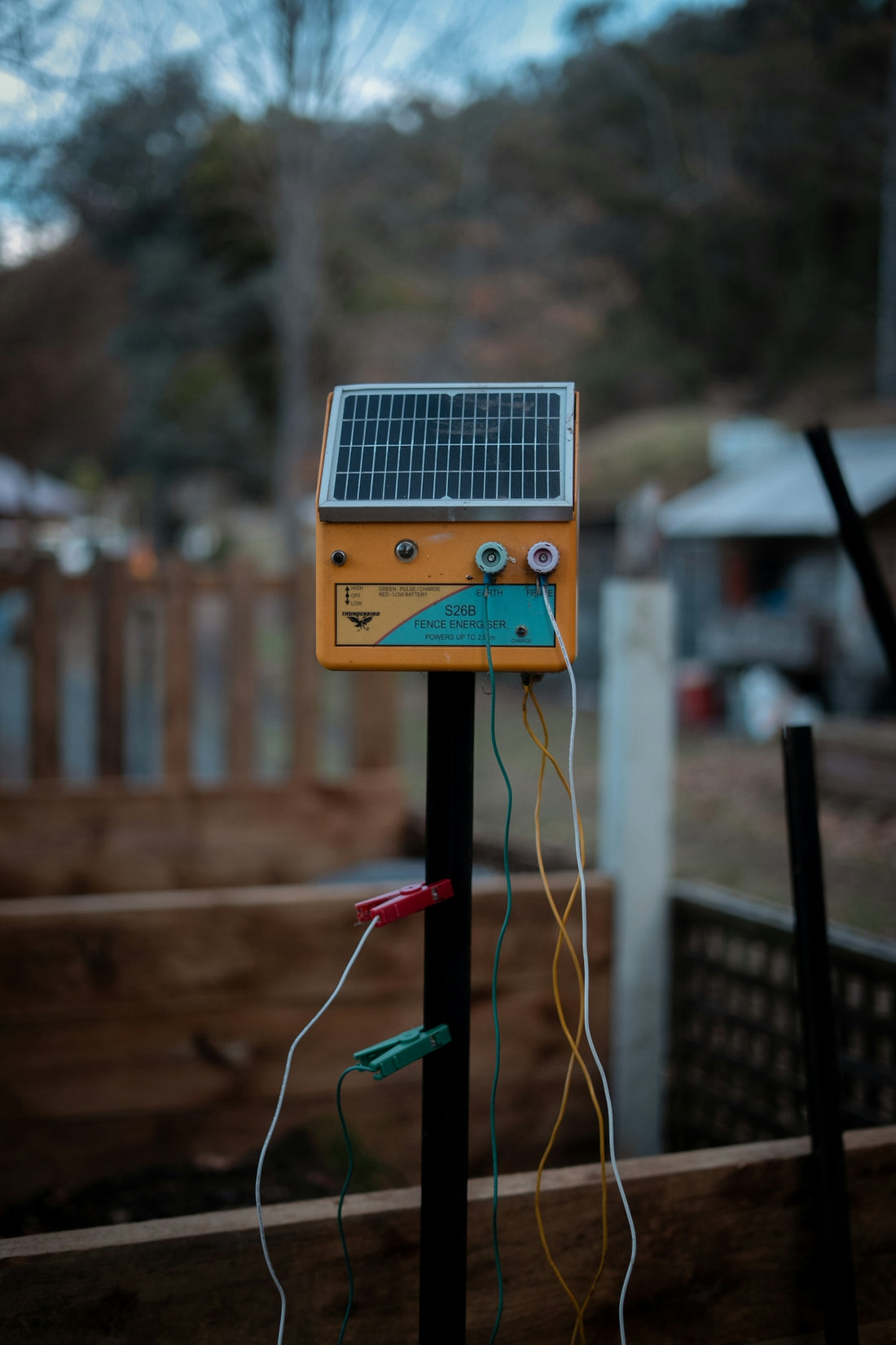 A solar-powered electric fence energizer is displayed.